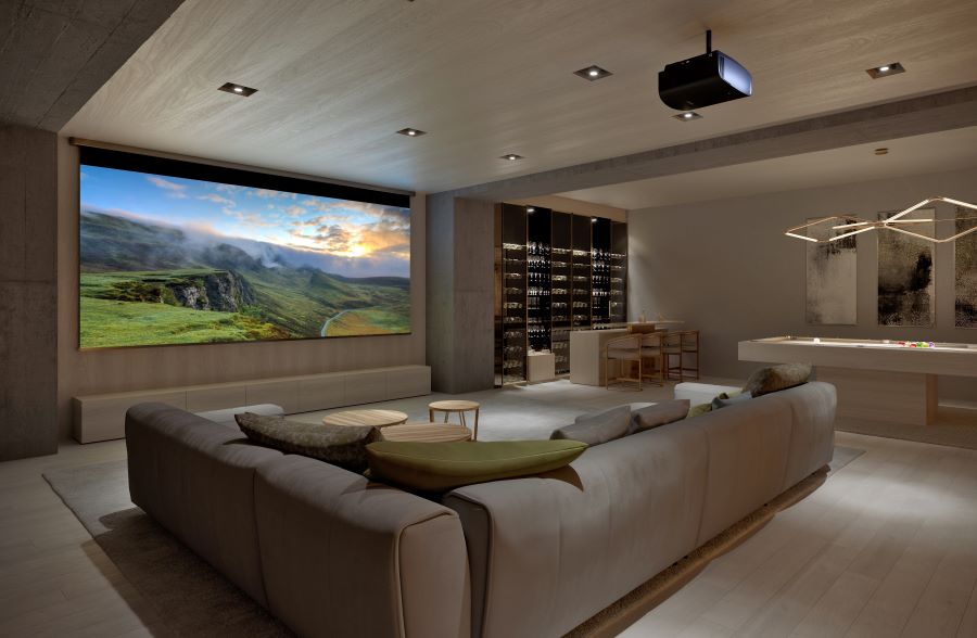 Luxury home cinema with large projection screen, comfortable seating, and integrated bar area