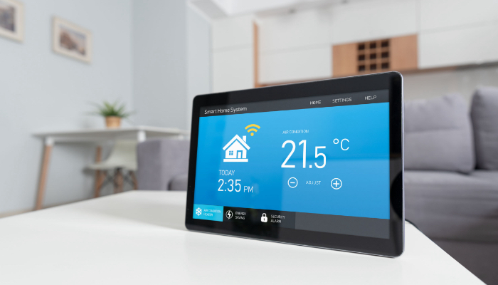 Smart thermostat showing temperature control interface in a modern living room
